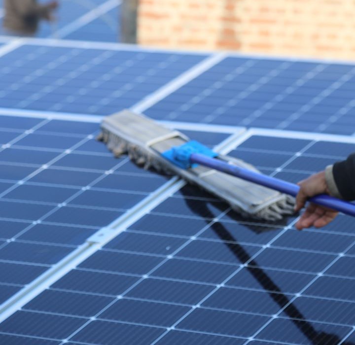 Soft brush and deionized water cleaning a solar panel